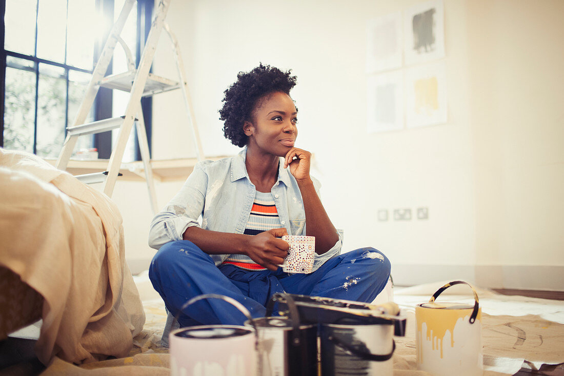 Satisfied woman painting living room