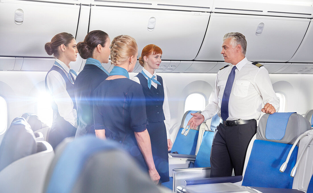 Pilot and flight attendants talking, preparing
