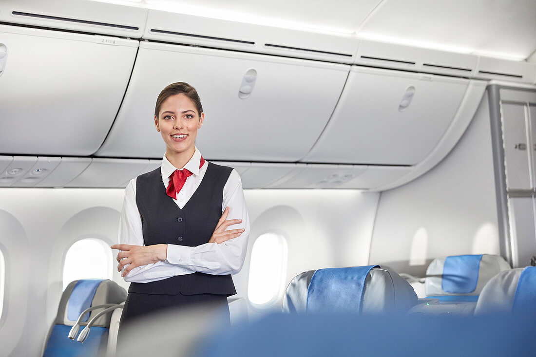 Portrait female flight attendant on airplane