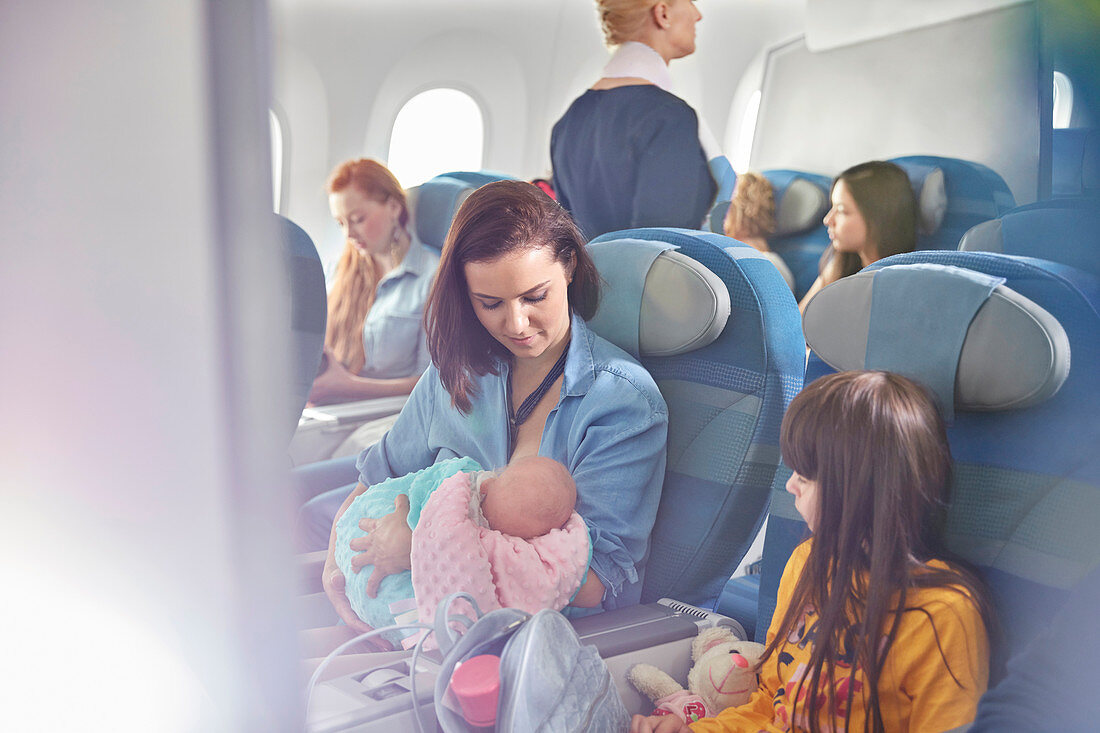 Mother holding baby on airplane