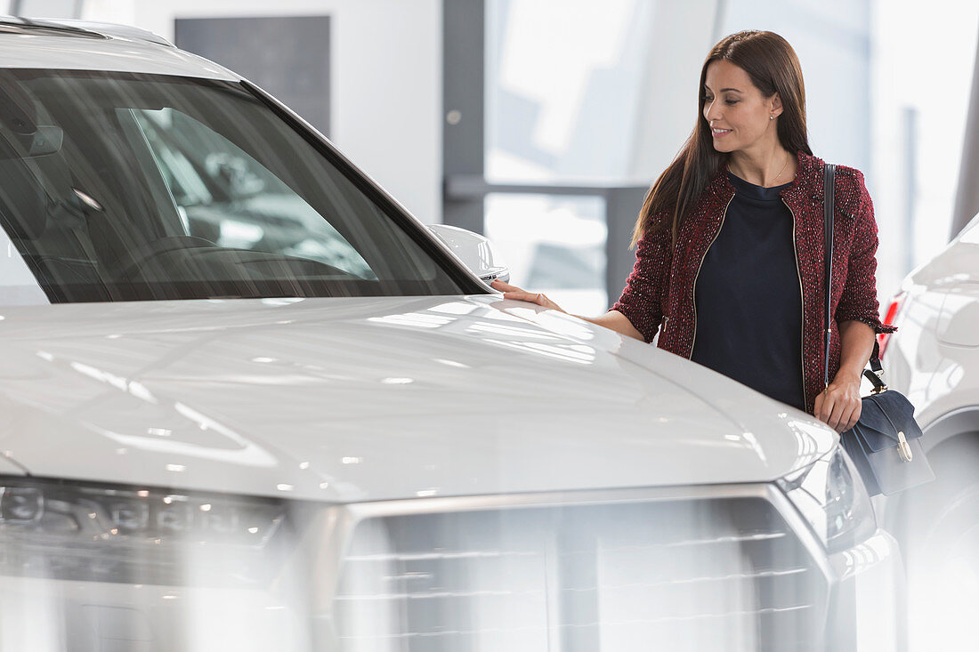 Female customer shopping for car in showroom