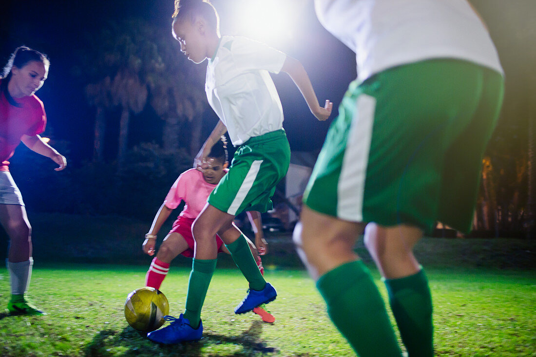 Young soccer players playing at night