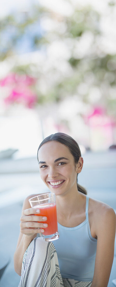 Smiling woman drinking juice