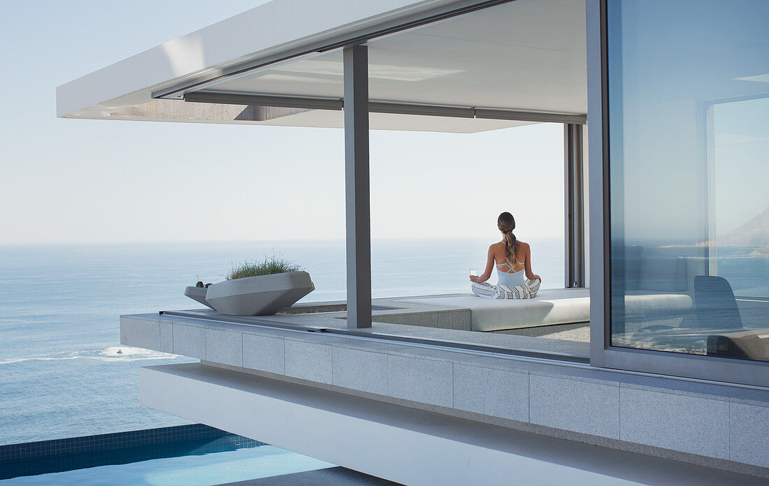 Serene woman meditating on patio