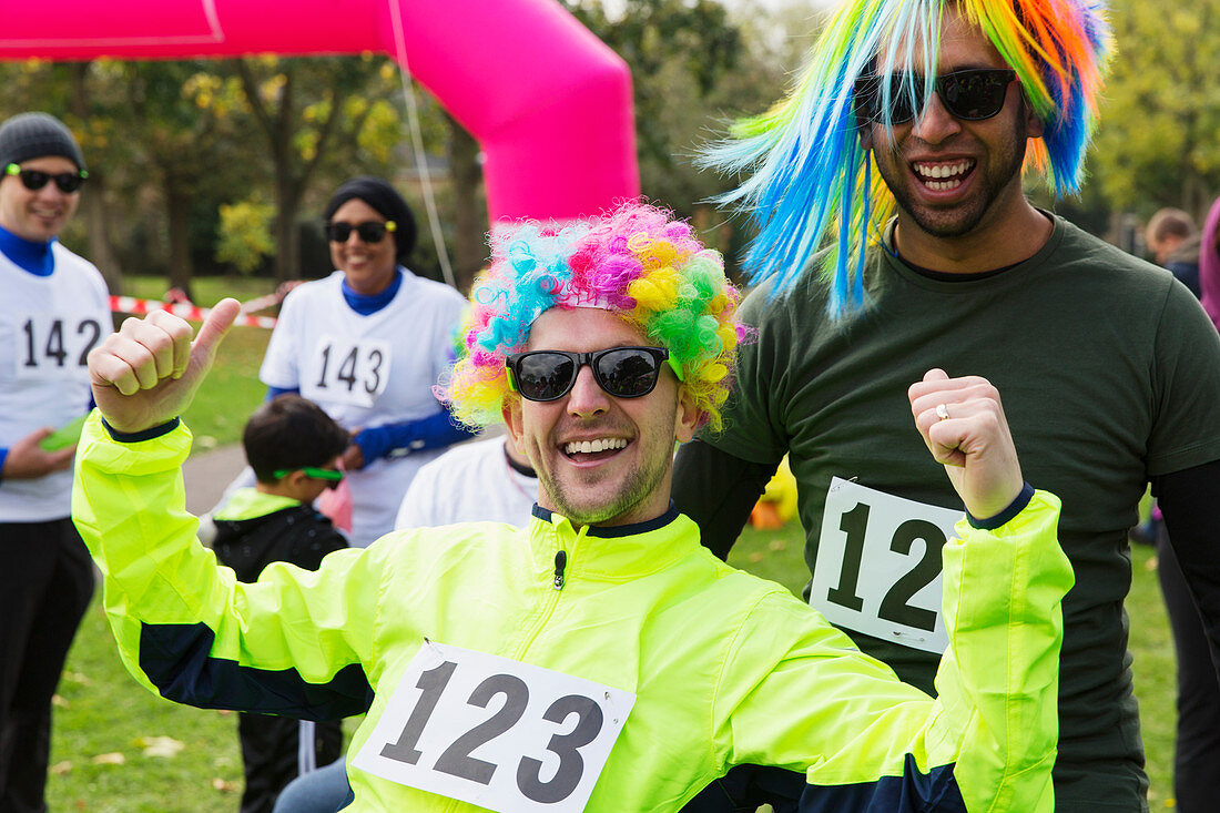 Portrait enthusiastic male runners wearing wigs