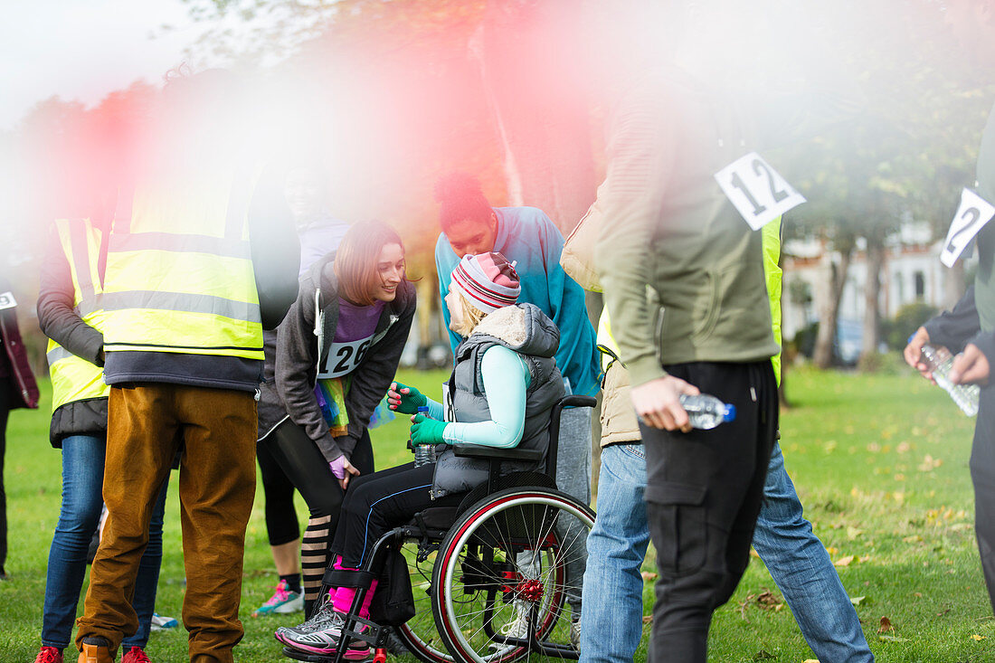 Woman in wheelchair talking to friends