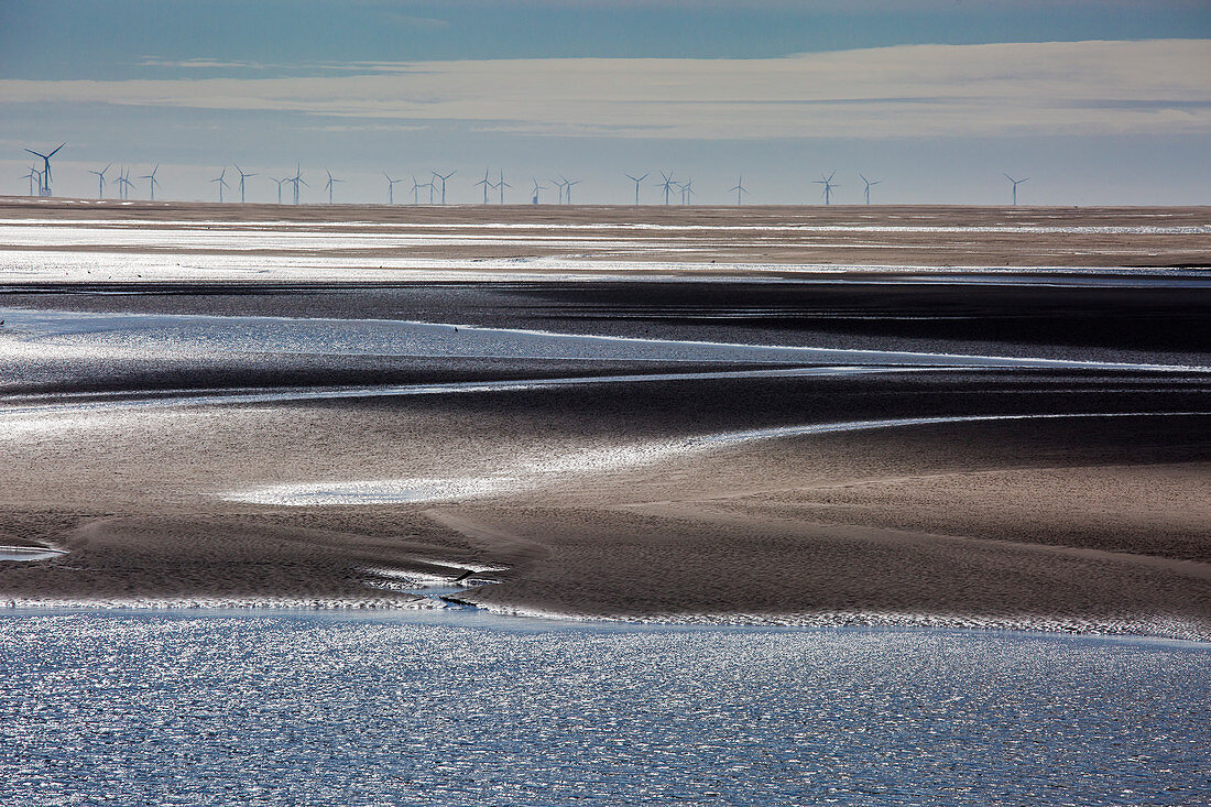 Wind turbines in distance beyond bay, UK