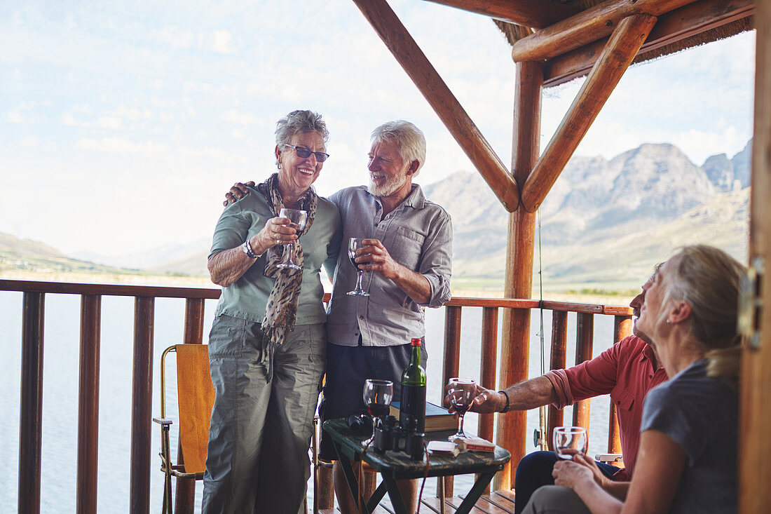 Happy active senior couples drinking wine