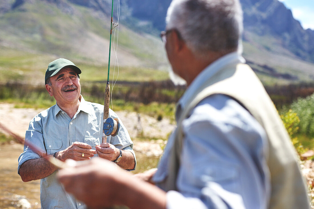 Smiling active senior men fishing