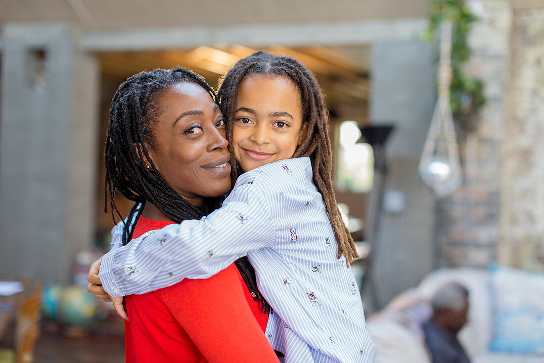 Portrait smiling mother and daughter hugging