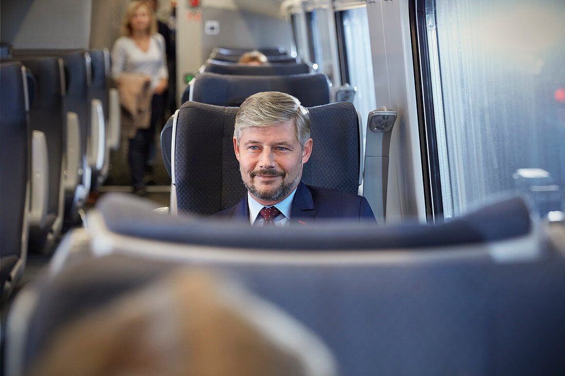 Confident businessman on train
