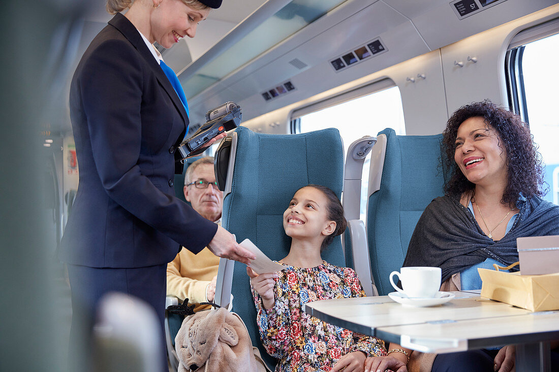 Attendant checking ticket of mother and daughter
