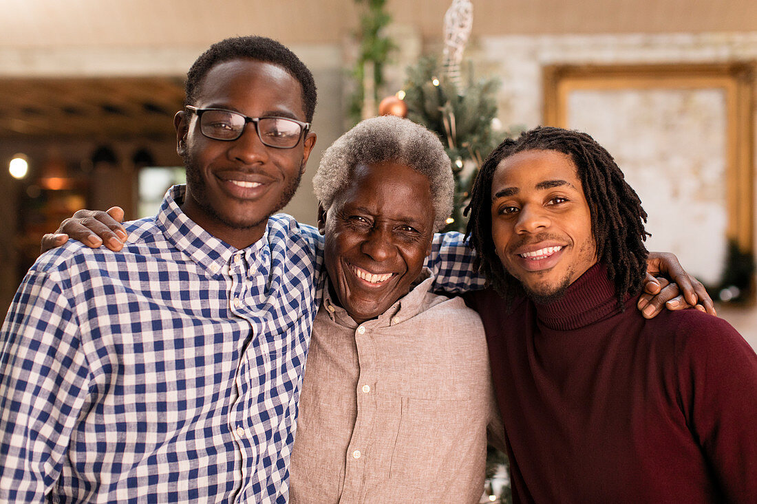 Portrait grandfather and grandsons hugging