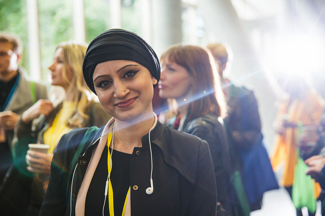Portrait smiling woman in headscarf at conference