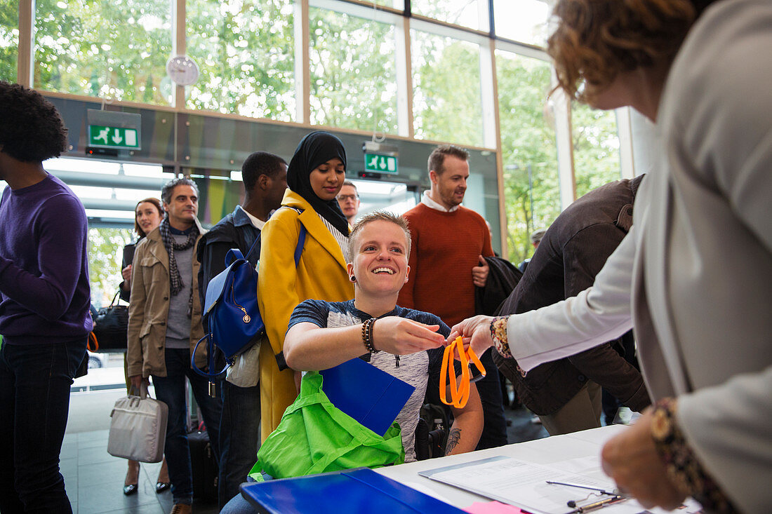 Woman in wheelchair checking in at conference