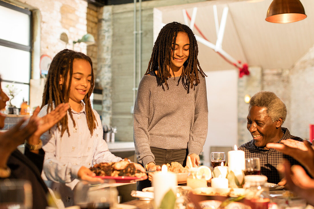 Multi-generation family serving Christmas dinner