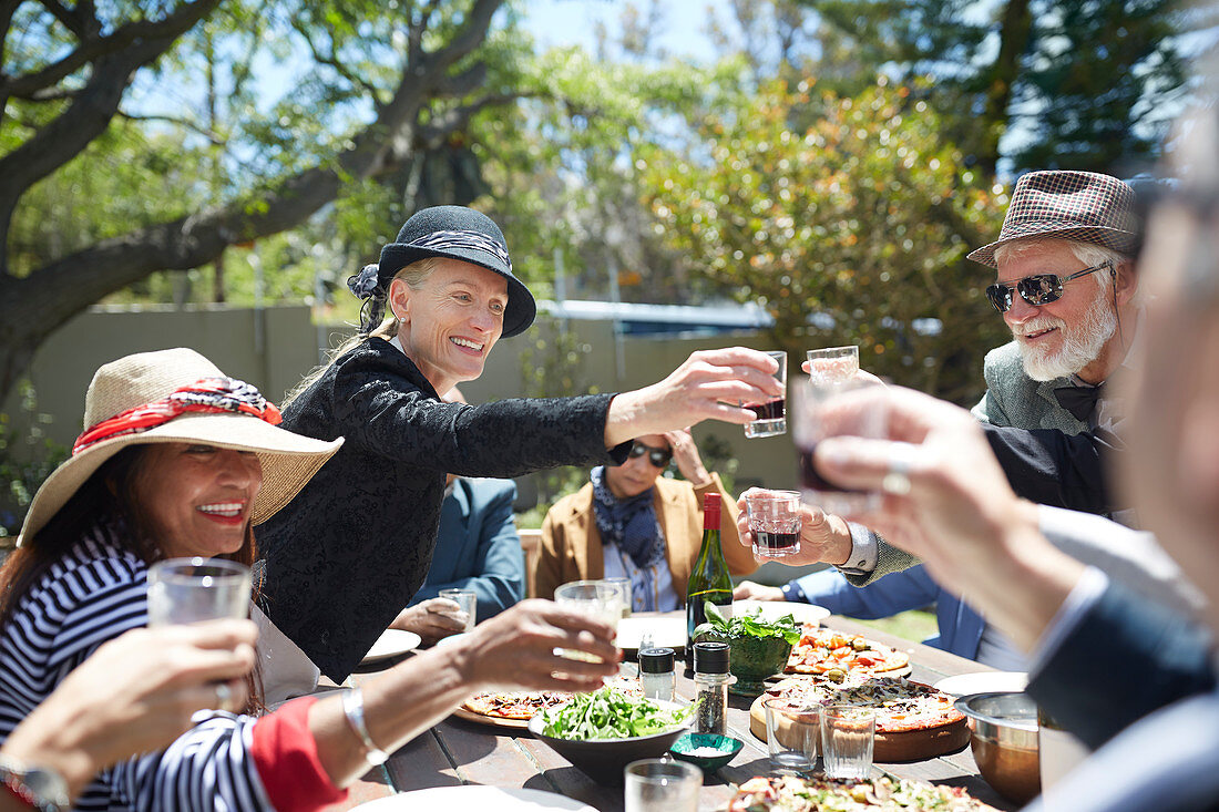 Happy senior friends toasting wine glasses