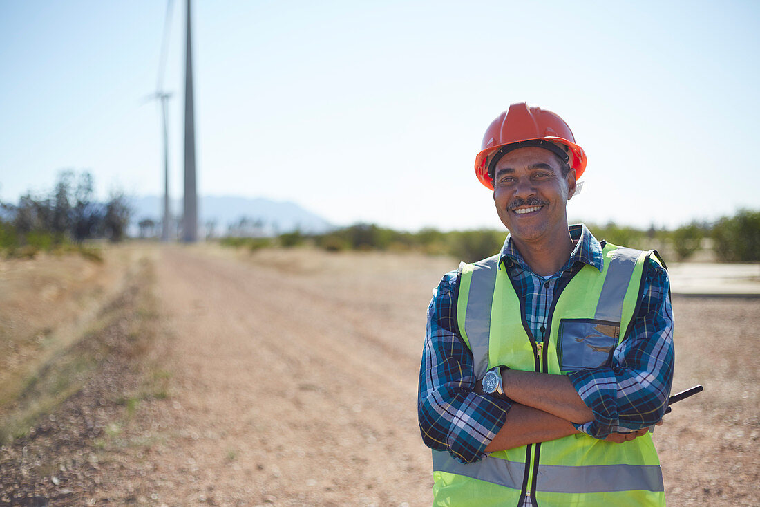 Portrait smiling engineer on dirt road