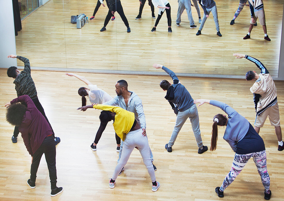 Instructor guiding students in dance class studio