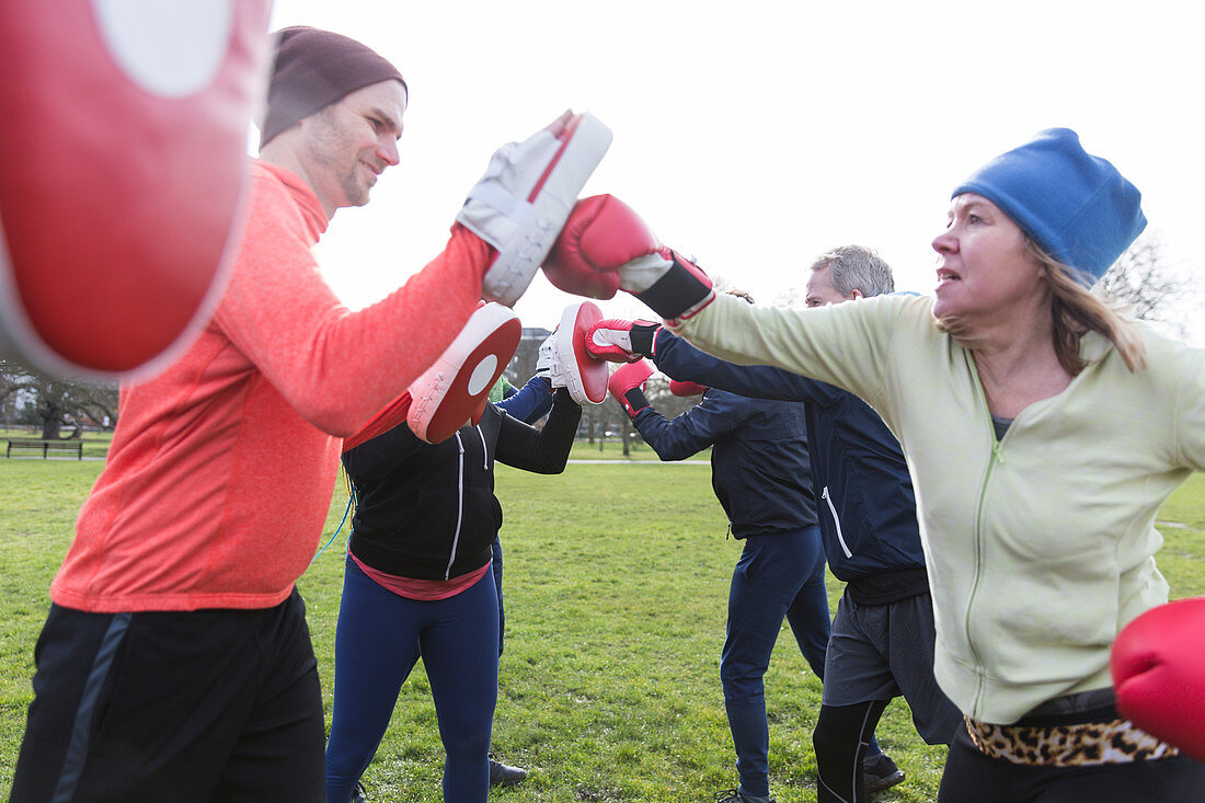 Determined woman boxing in park