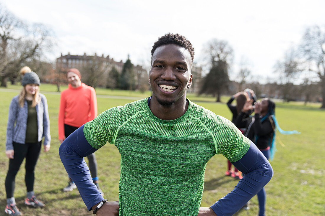 Portrait smiling male runner in sunny park
