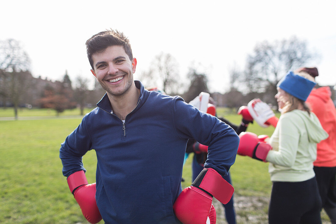 Portrait smiling man boxing in park