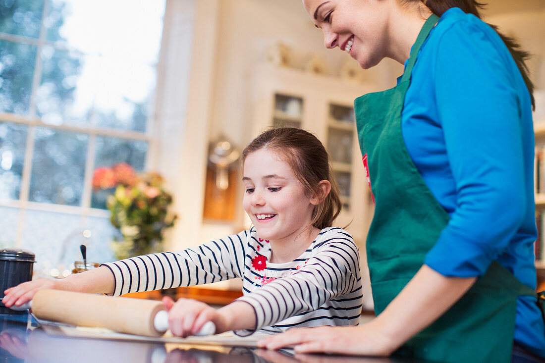 Mother and daughter baking in kitchen