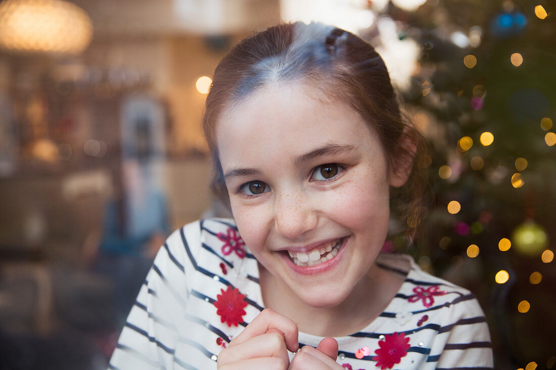 Portrait smiling girl in Christmas living room