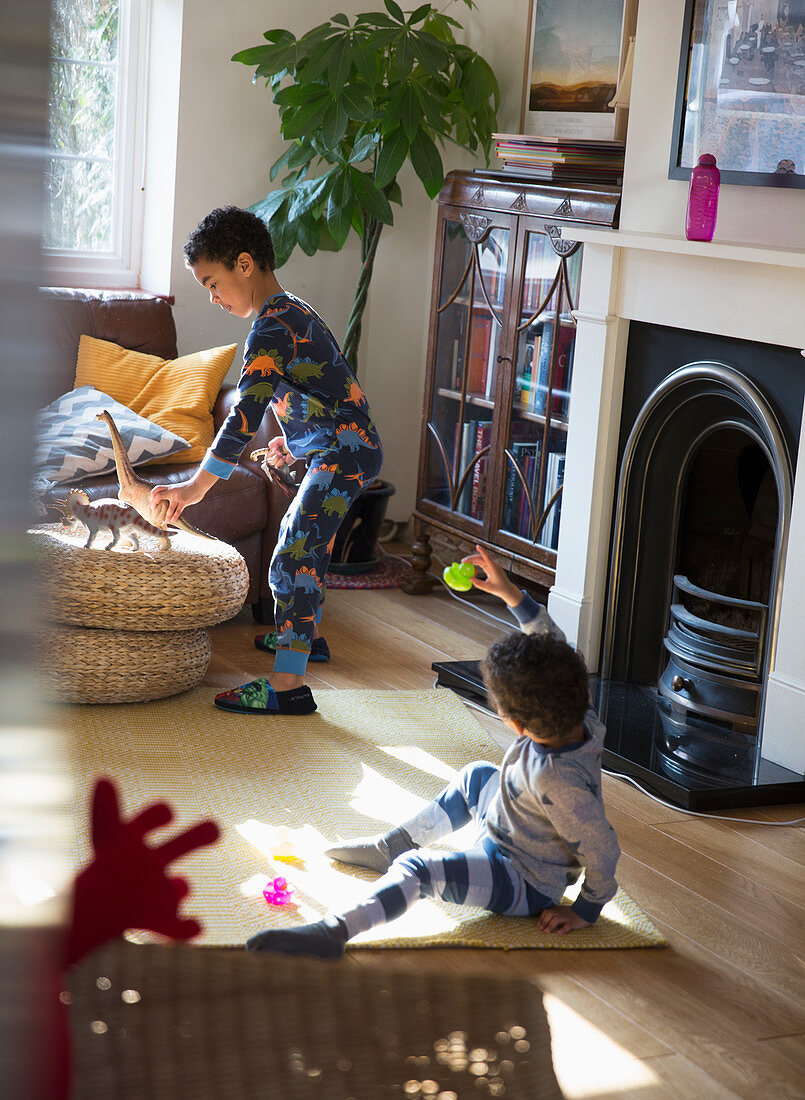 Brothers in pyjamas playing with toys