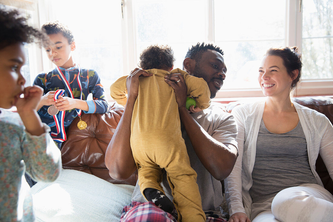 Happy multi-ethnic family on sofa