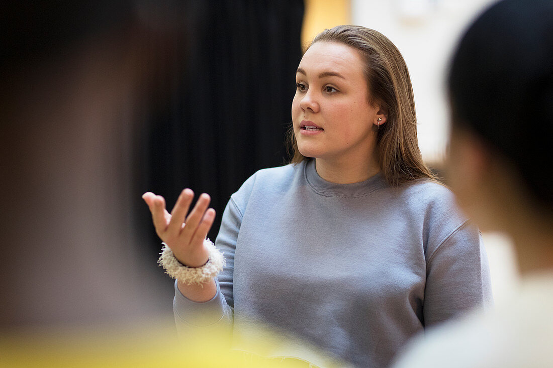 Focused teenager girl leading discussion