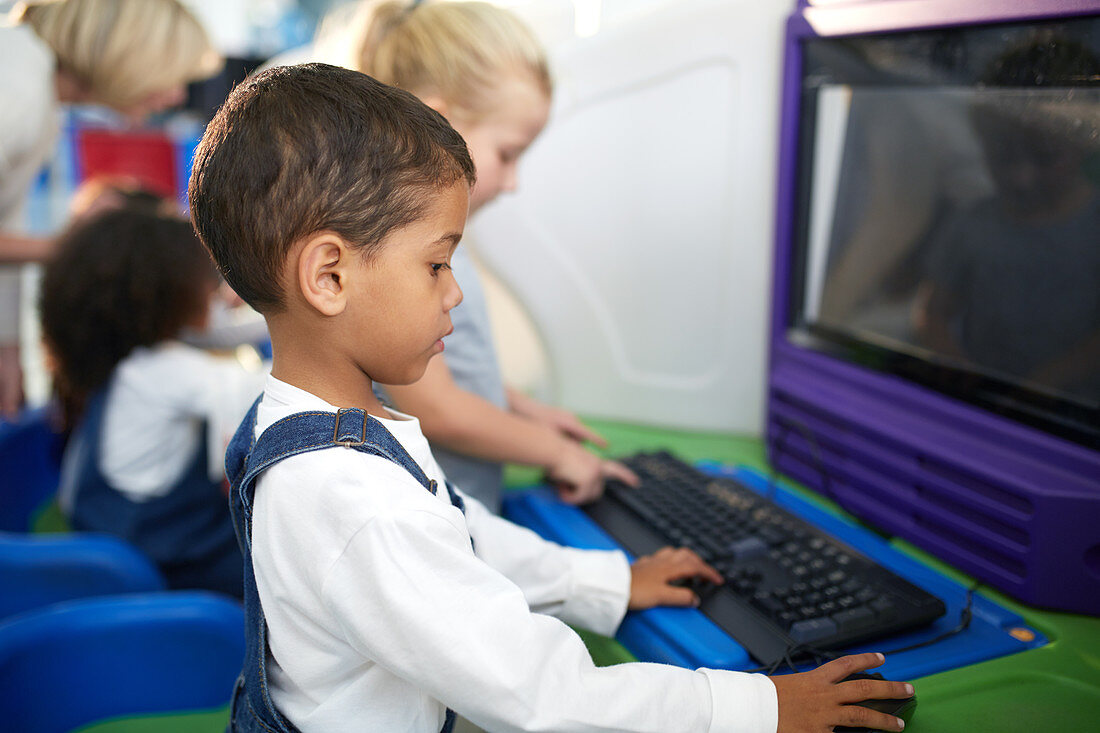Curious boy using computer