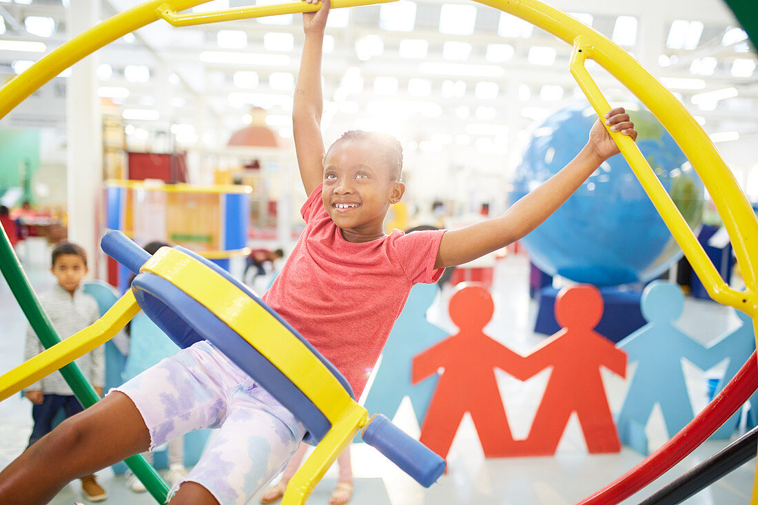 Girl using gyroscope in science centre