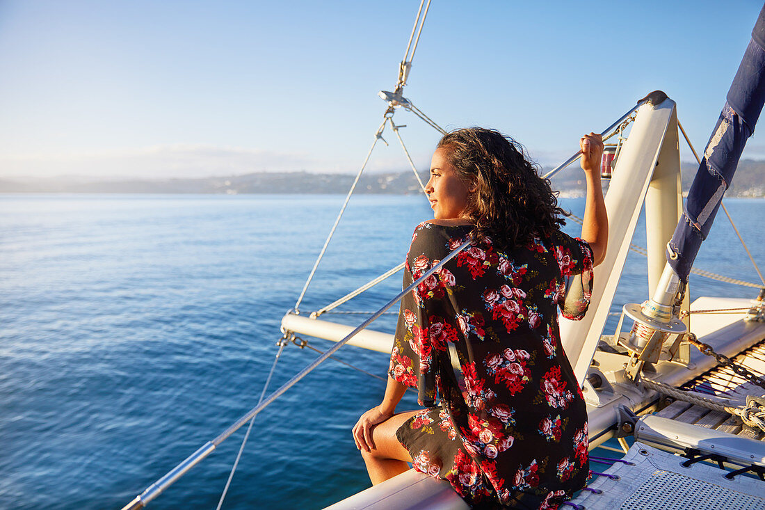 Woman relaxing on sunny catamaran