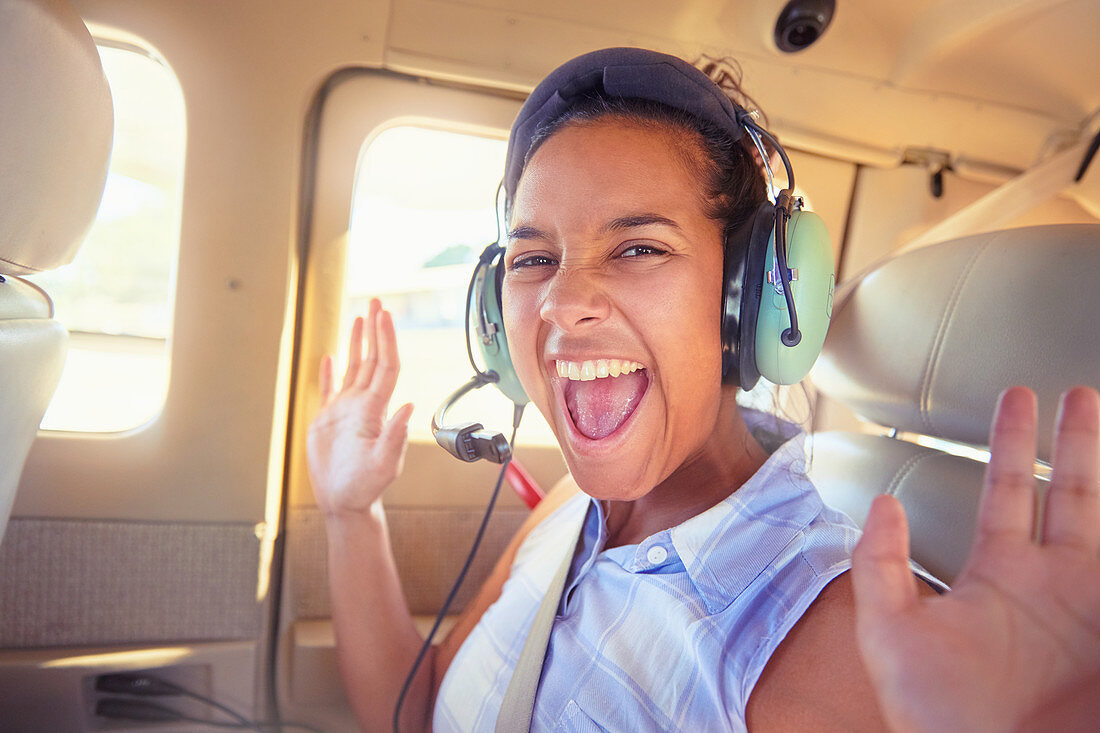 Portrait of young woman riding in airplane