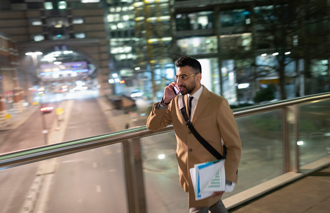 Businessman, walking on bridge at night