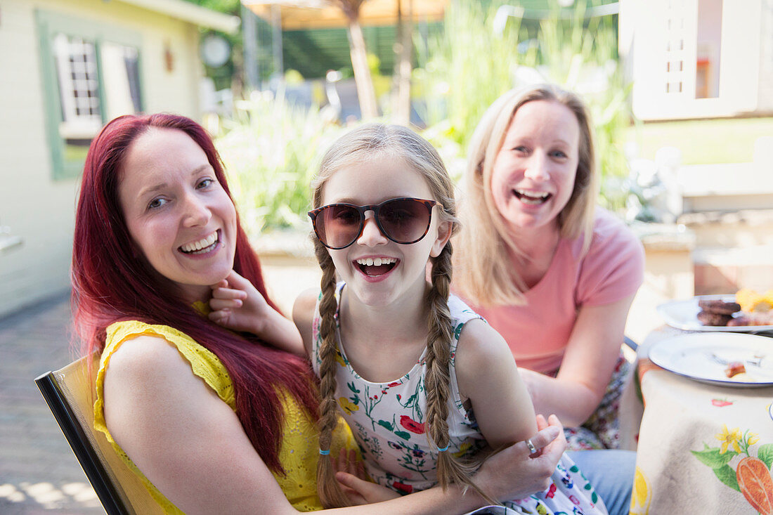 Lesbian couple and daughter with sunglasses