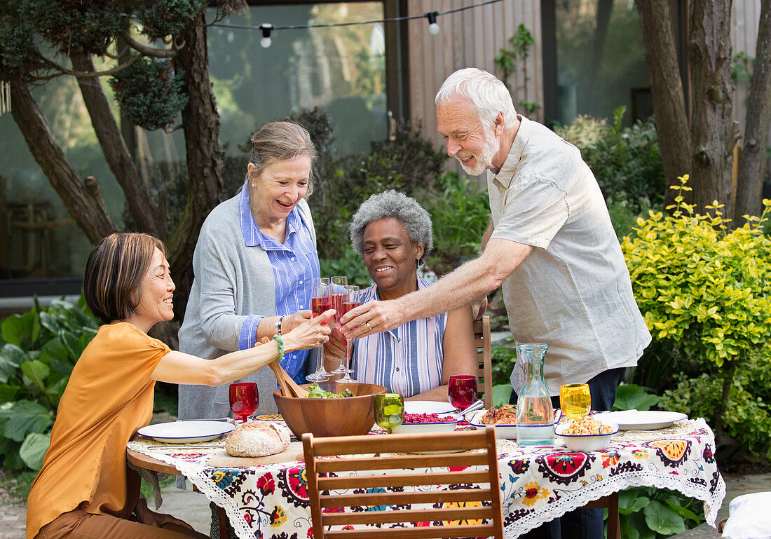 Senior friends enjoying wine and lunch