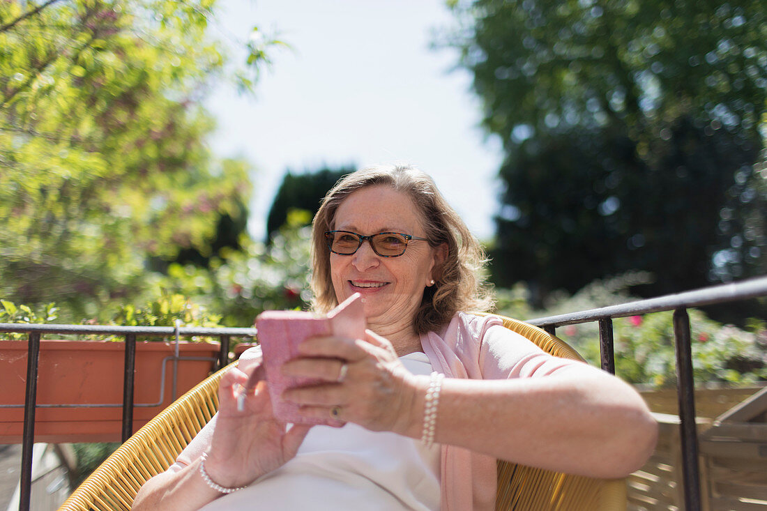 Happy senior woman using smart phone