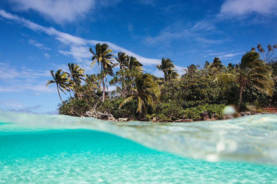 Tropical island beach beyond ocean surface
