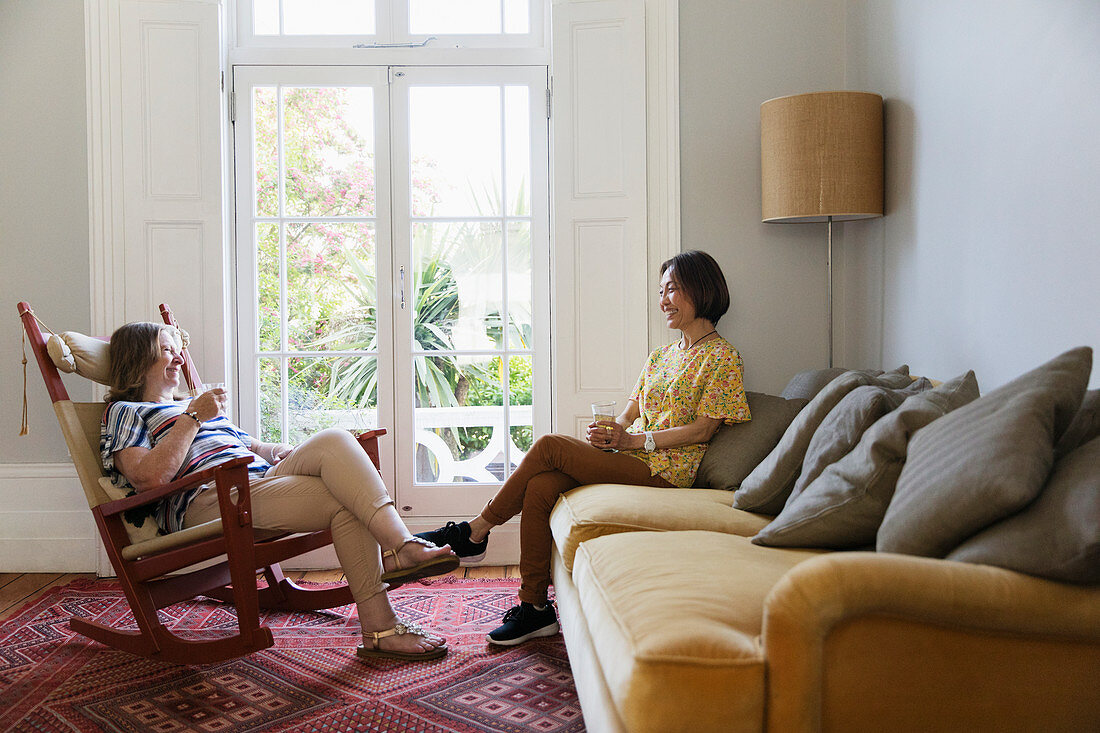 Senior women friends talking in living room