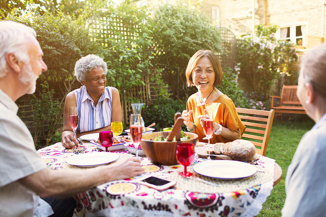 Active senior friends enjoying garden party