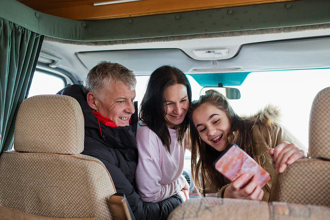 Happy family taking selfie in motor home