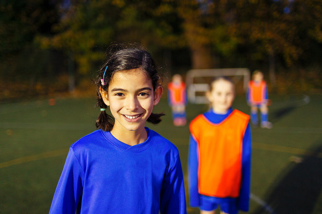 Portrait girl playing soccer