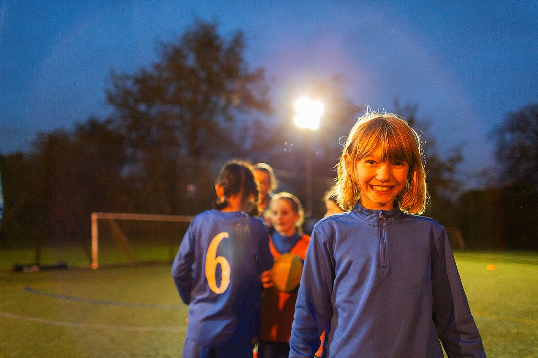 Portrait girl playing soccer with team