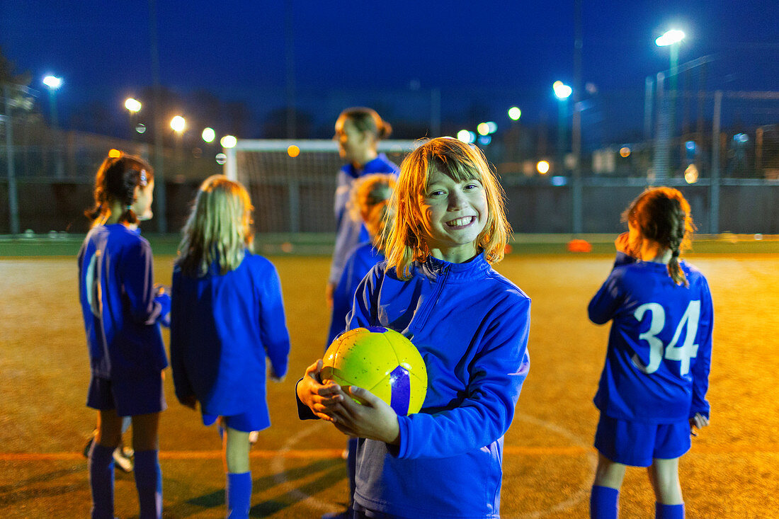 Portrait smiling, girl enjoying soccer practice