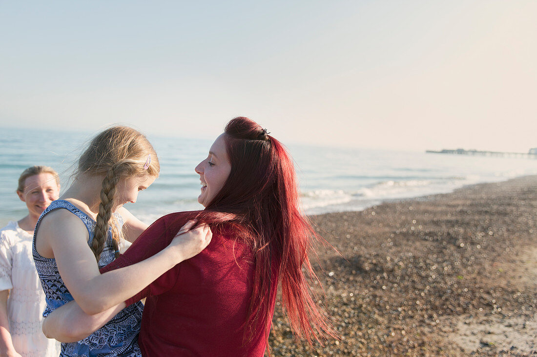 Lesbian couple and daughter on beach