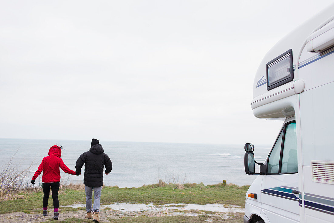 Couple holding hands outside motor home