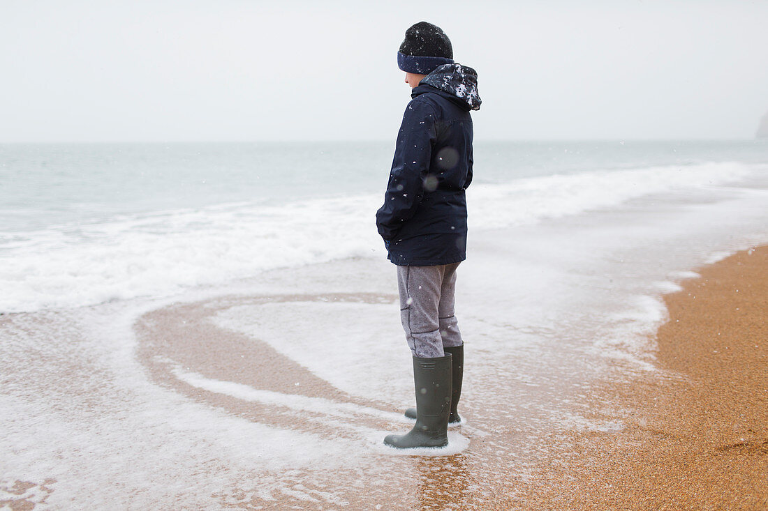 Teenage boy in rubber boots