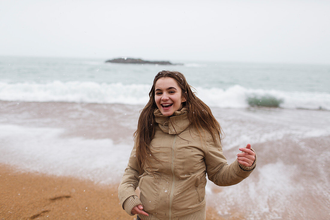 Portrait happy, carefree girl on beach